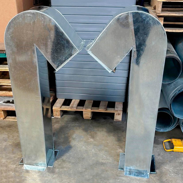 Pair of galvanized HVAC elbow ducts with protective mesh grilles